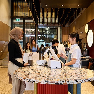 Woman buying coffee at cafe