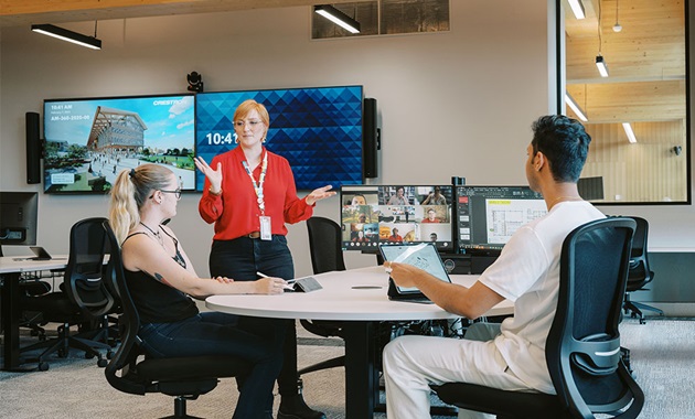 Teacher with two students and computers