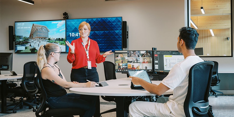 Teacher with two students and computers