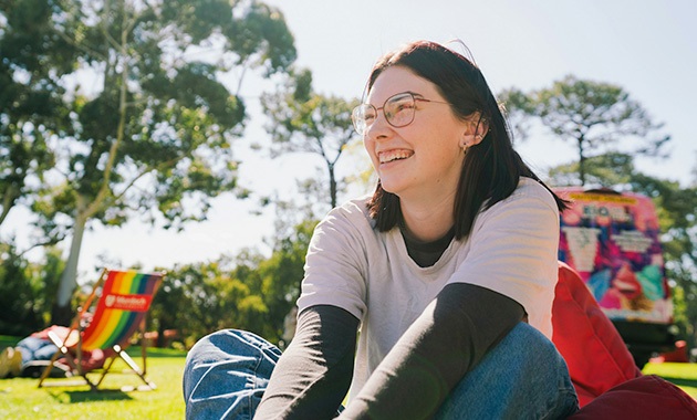 Young person on beanbag with Bush Court in background