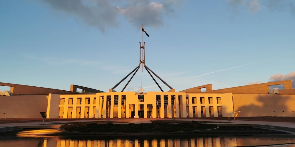 Australian Parliment building at sunset with blue skies