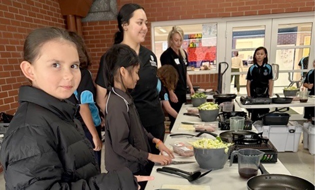 young students cooking
