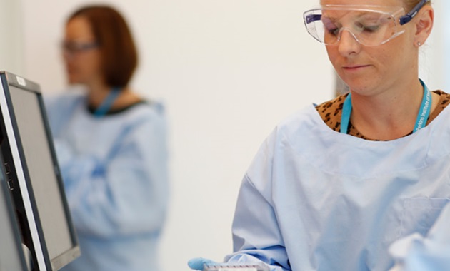 Identifying disease biomarkers for predictive medicine researcher looking at sample