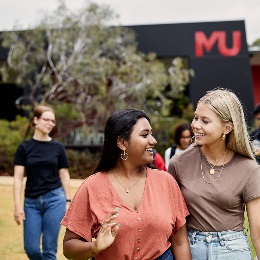 A group of students laughing and chatting on Bush Court