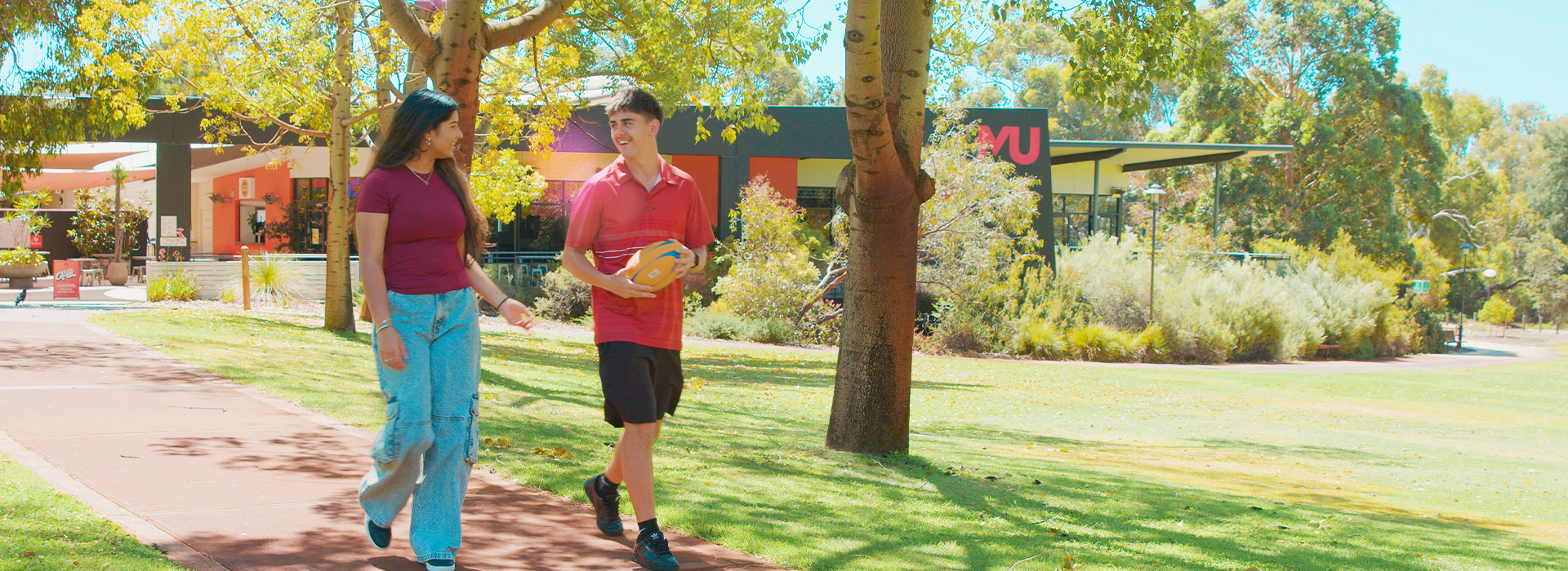 two students walking across bush court