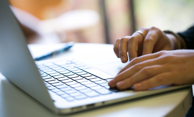 Closeup of someone using a laptop.