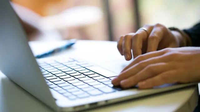 Closeup of someone using a laptop.