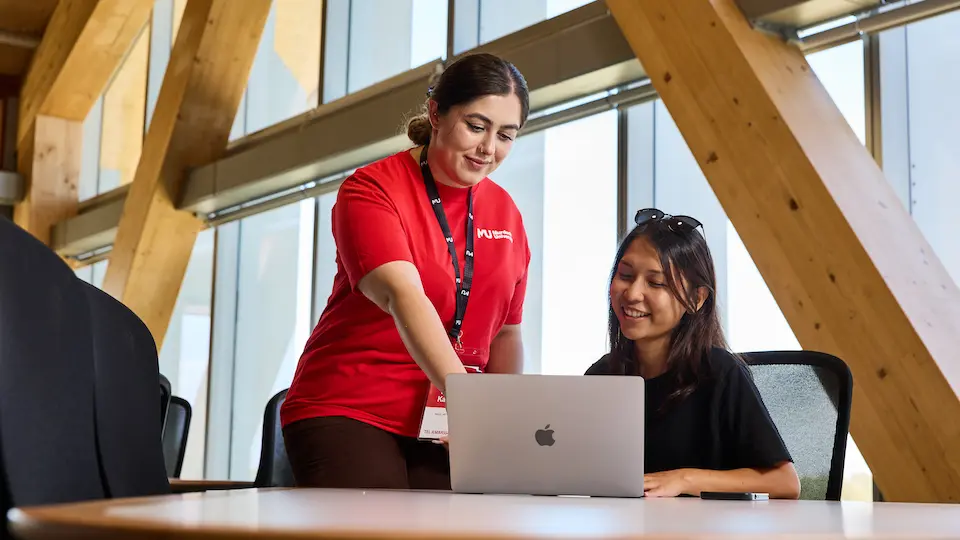 Murdoch staff member helping student