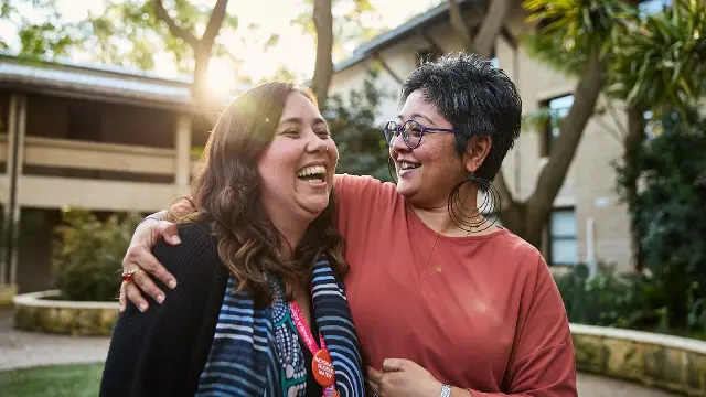 Staff hugging eachother located at Marion Blackwell Garden