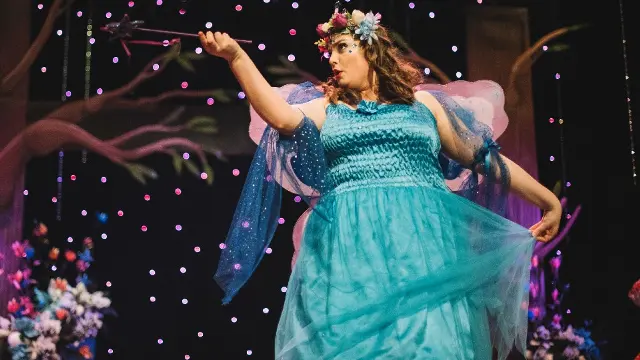 An actress in a fairy costume onstage at Nexus Theatre.
