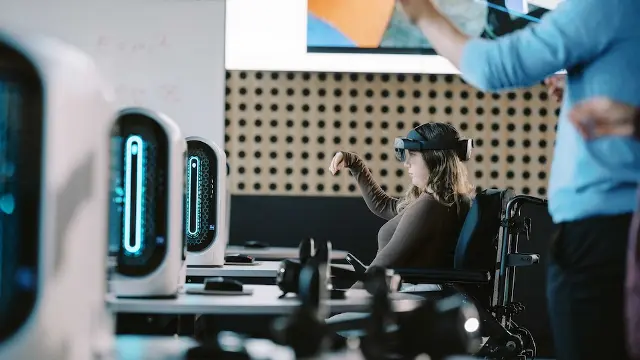 Student gesturing with headset in computer lab