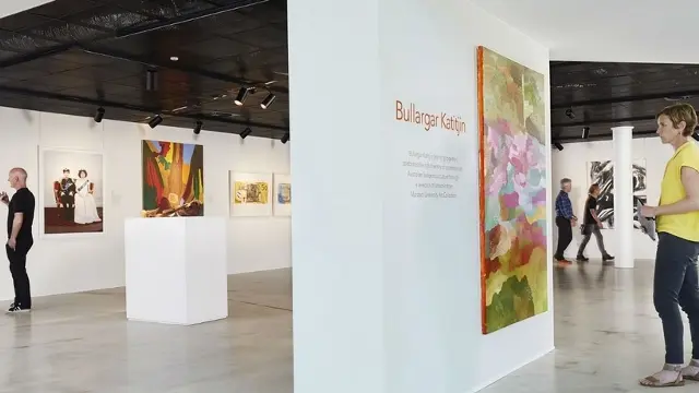 Visitors browsing art gallery