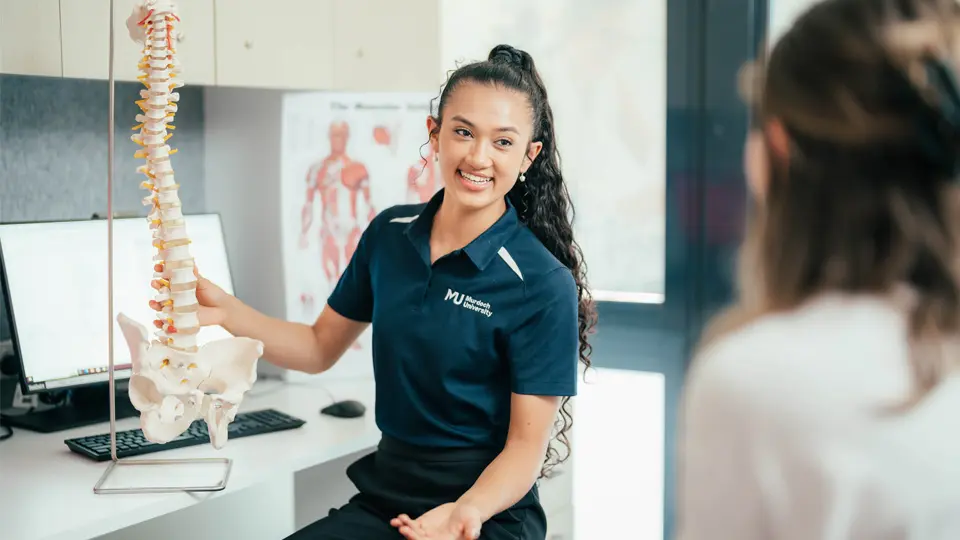 A Chiropractic student explaining treatment in the Chiropractic Clinic