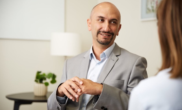 Male psychologist in session with patient.