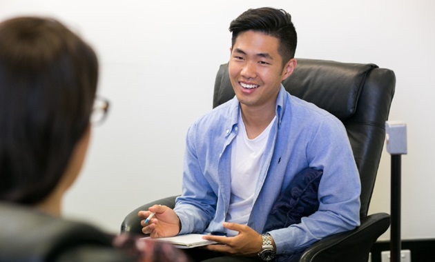 Male psychologist in session with patient.