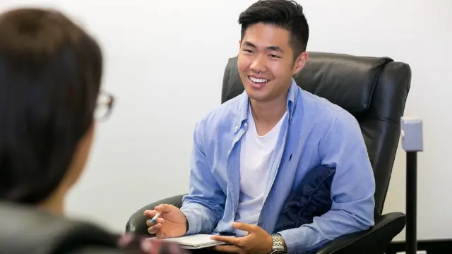 Male psychologist in session with patient.