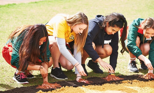 Students with their hands on the ground at a Kulbardi Deadly Dreaming event