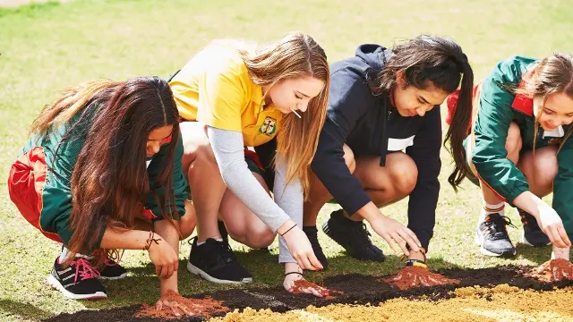 Students with their hands on the ground at a Kulbardi Deadly Dreaming event