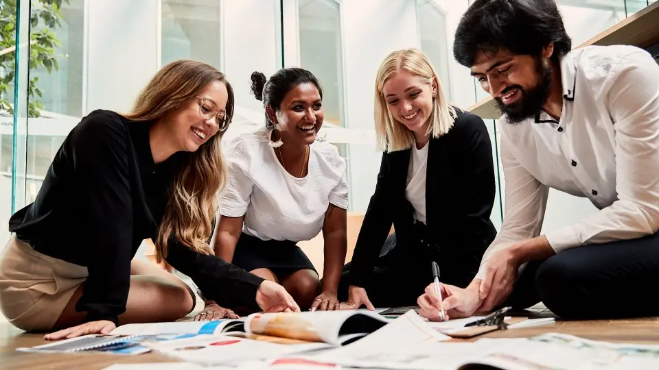 Four business students working together in the CBD office.