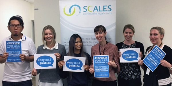 law team holding equal justice signs