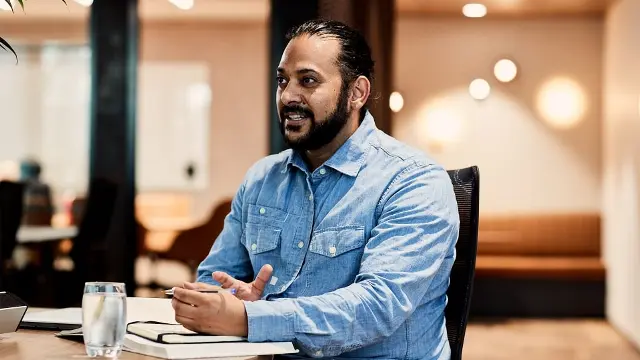 A male postgraduate business student working in the CBD office