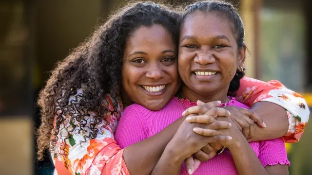 Two women from Kulbardi Aboriginal Centre hugging