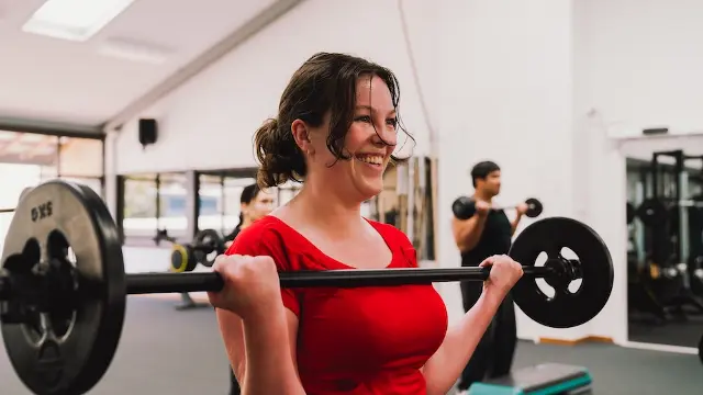 Murdoch University staff member lifting weights in Murdoch gym