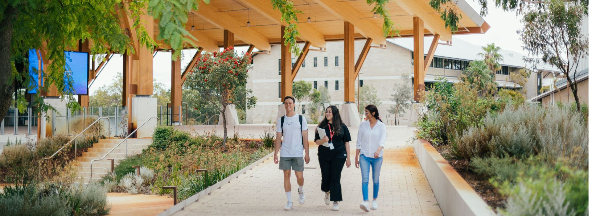 Three Murdoch University students walking outside Boola Katitjin