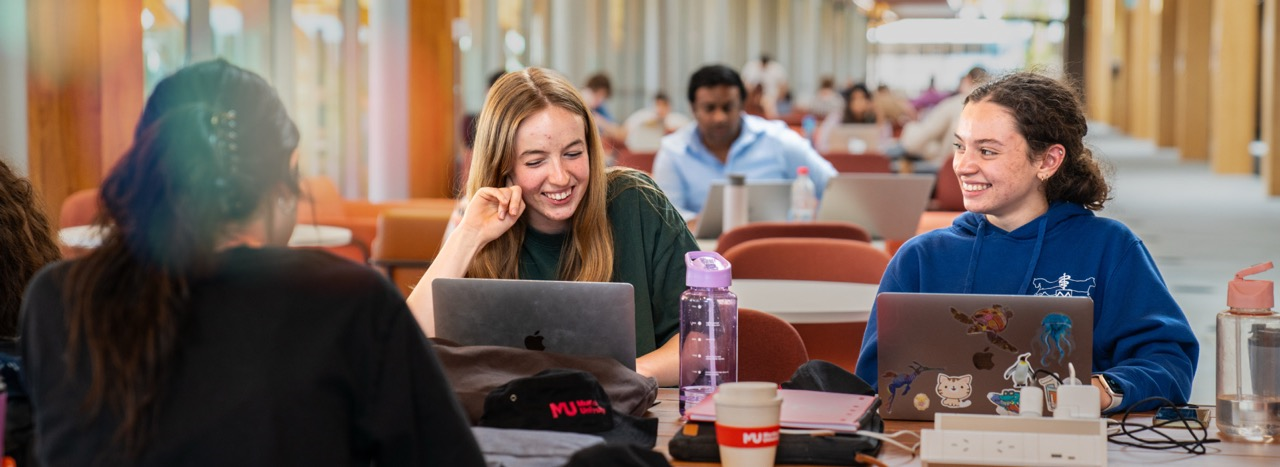 Murdoch University students studying and smiling in Boola Katitjin