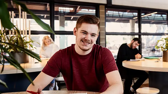 Smiling Murdoch student in cafe