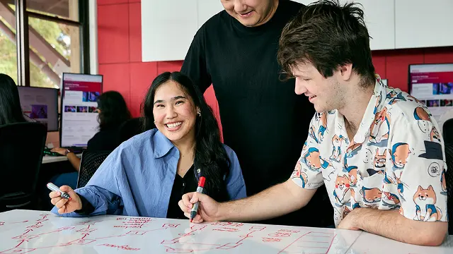 IT students collaborating on a project in a computer lab