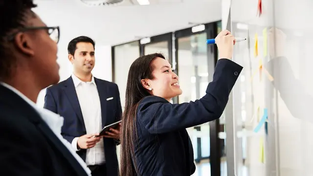 Business professionals collaborating on a project using sticky notes