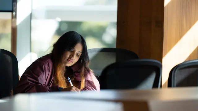 Student studying independently in a campus study space