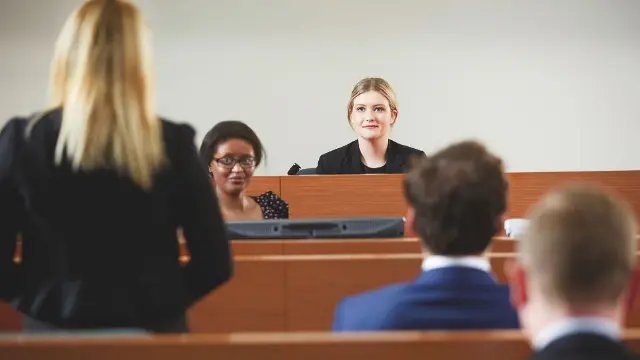 Law student presenting a case in a moot court setting