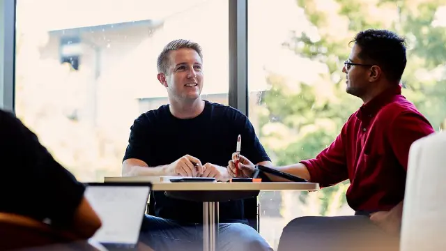 Business students in discussion in a campus study area