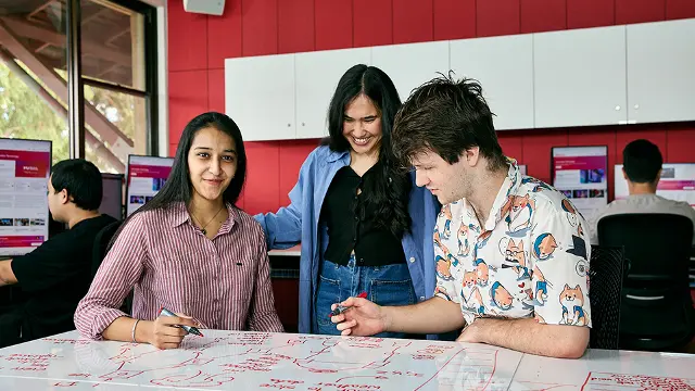 IT students collaborating on a project in a computer lab