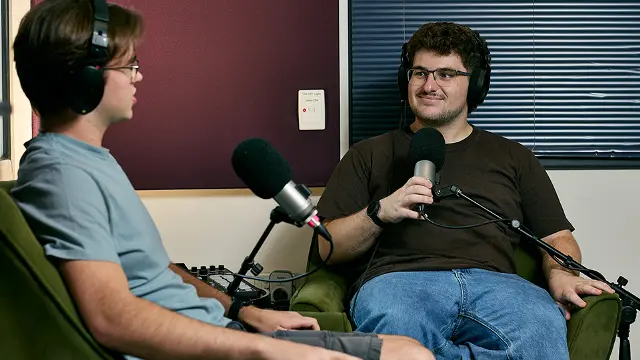 Students recording a podcast in a campus studio