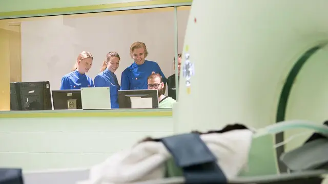 Vet Science students working at computers in a clinical simulation space