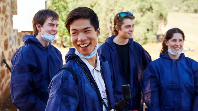 Forensic science students laughing together outdoors on campus