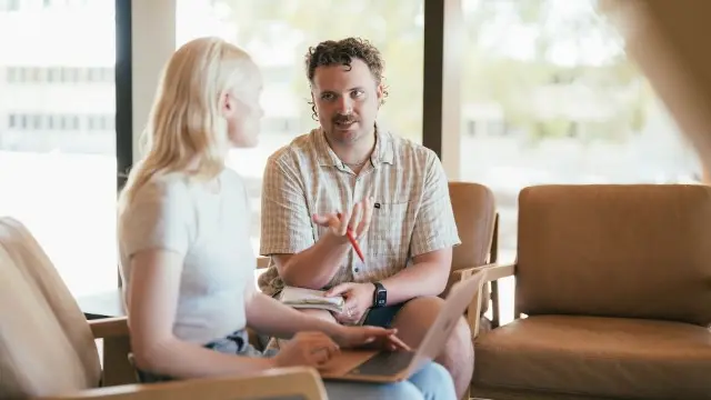 Murdoch staff member and student talking in a casual setting