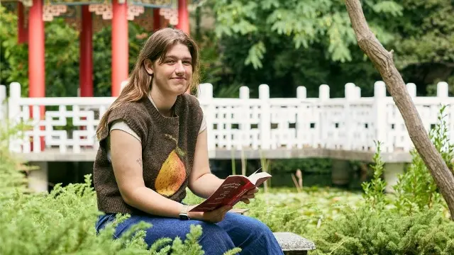 Murdoch student reading in Chinese Garden