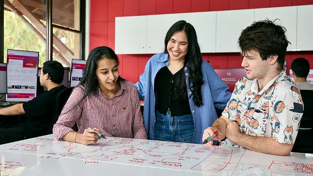 IT students collaborating on a project in a computer lab