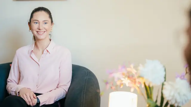 Psychology student smiling during a therapy or consultation session