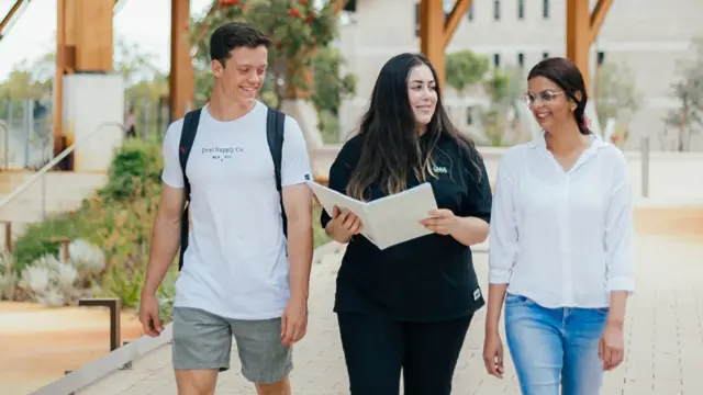 Students walking and talking together on campus