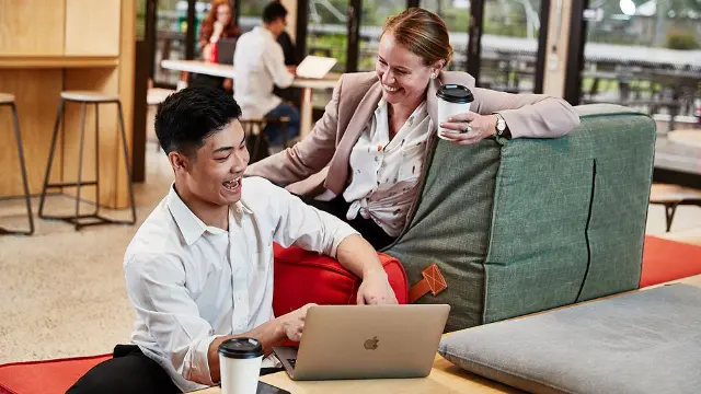 Business students working together in a relaxed campus setting