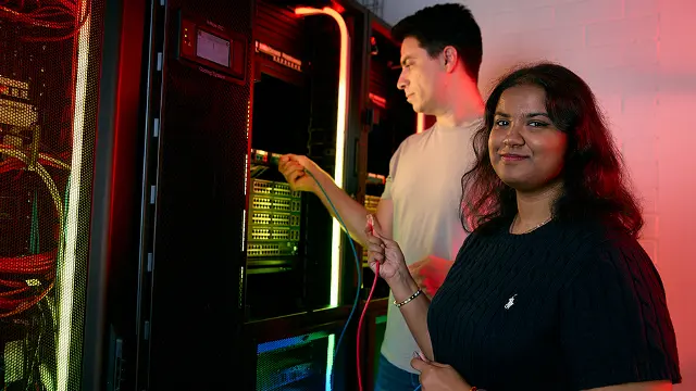 IT students smiling together in a computer lab
