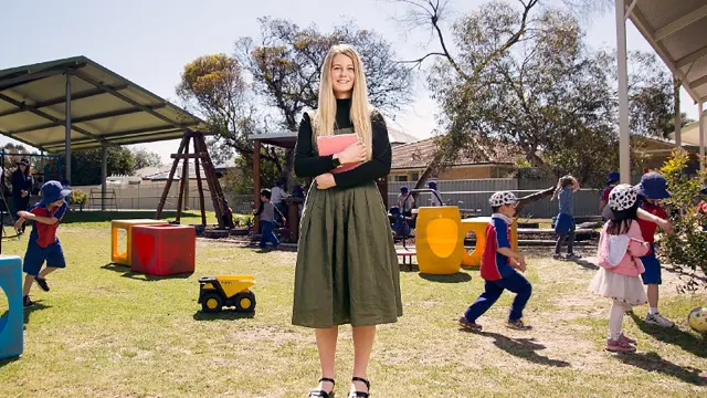 Education student supervising children during an outdoor school activity