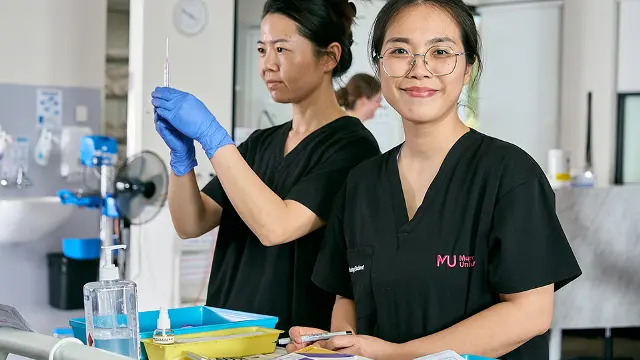 Nursing students with syringe and paperwork
