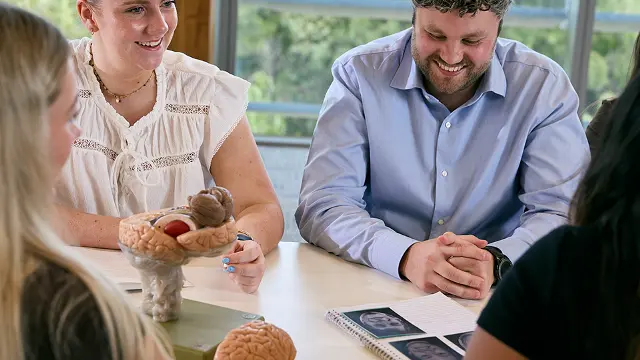 Psychology students with brain model