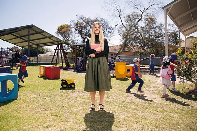 Student teaching in playground with children